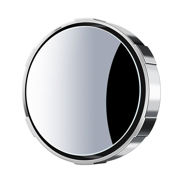 Round metallic object with reflective surface on a white background