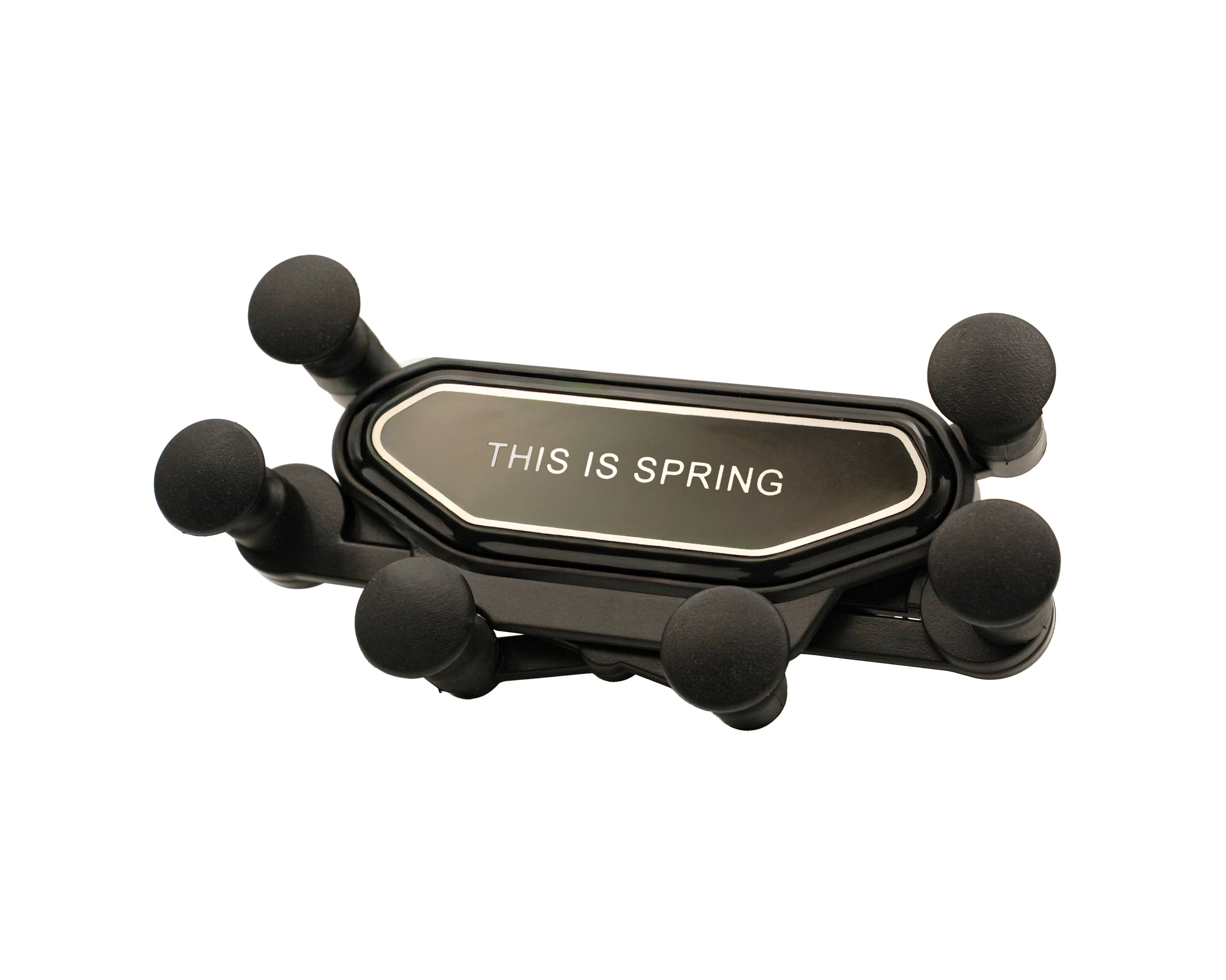 Black phone holder with 'THIS IS SPRING' text on a white background