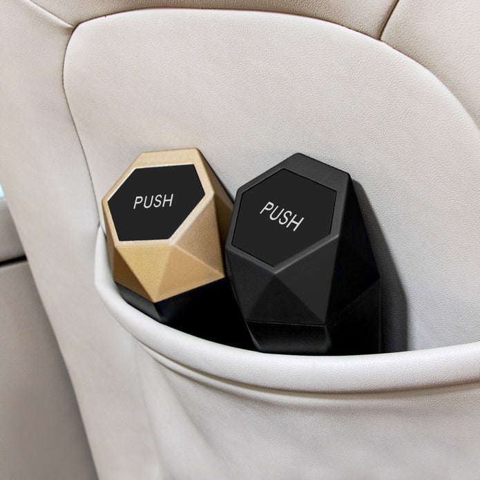 Two hexagonal car cup holders with 'PUSH' labels on a beige car seat.