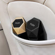 Two hexagonal car cup holders with 'PUSH' labels on a beige car seat.