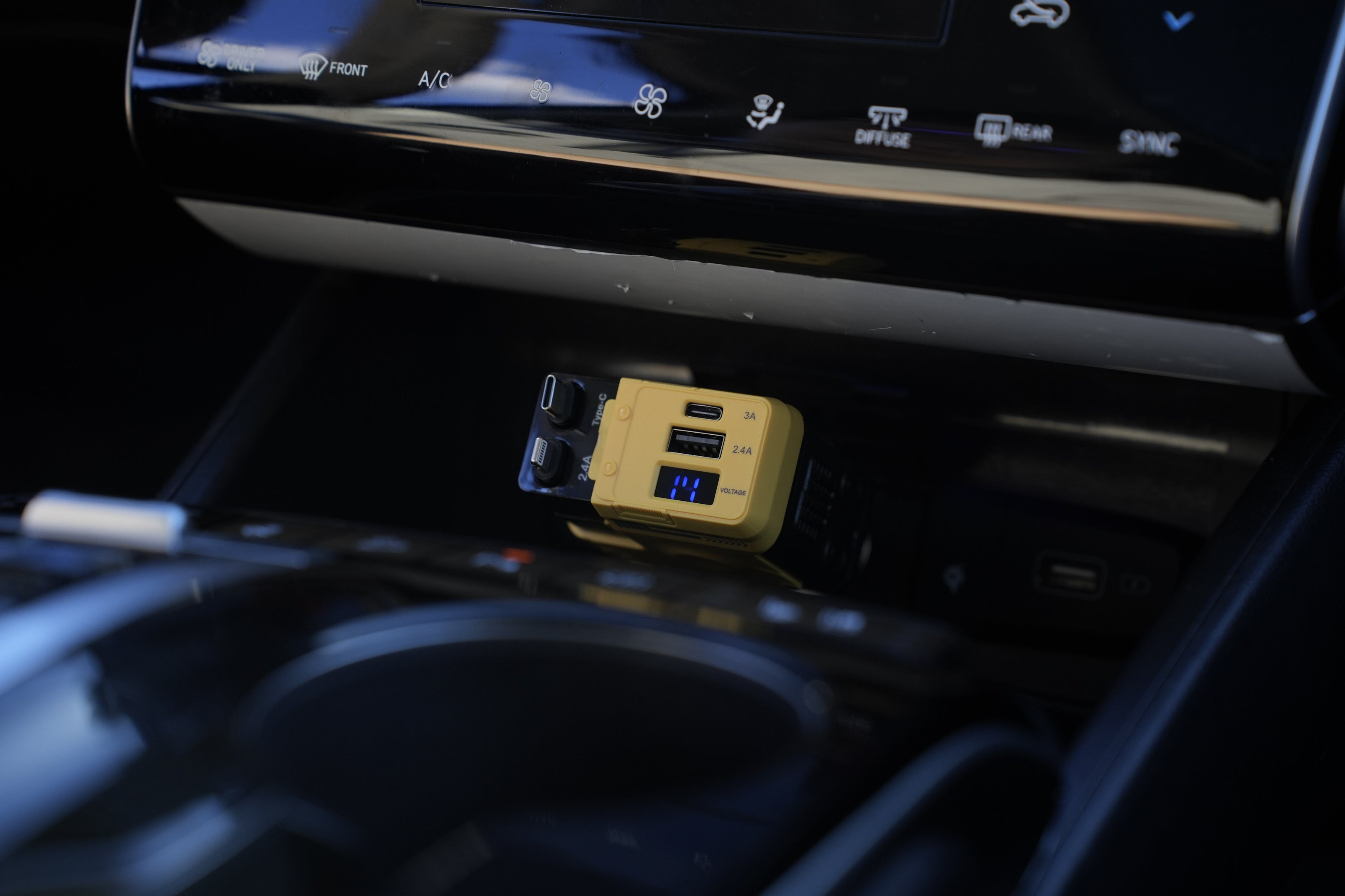 Car dashboard with a USB charger and cup holder