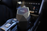 Hexagonal car air freshener with 'PUSH' label on a car dashboard