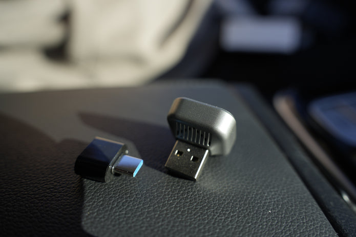 Two USB devices on a car dashboard