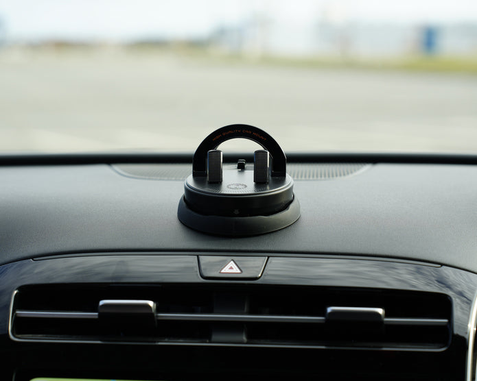 Car air freshener on a car dashboard with a blurred background