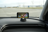 Phone mounted on a car dashboard displaying an app with cartoon characters.