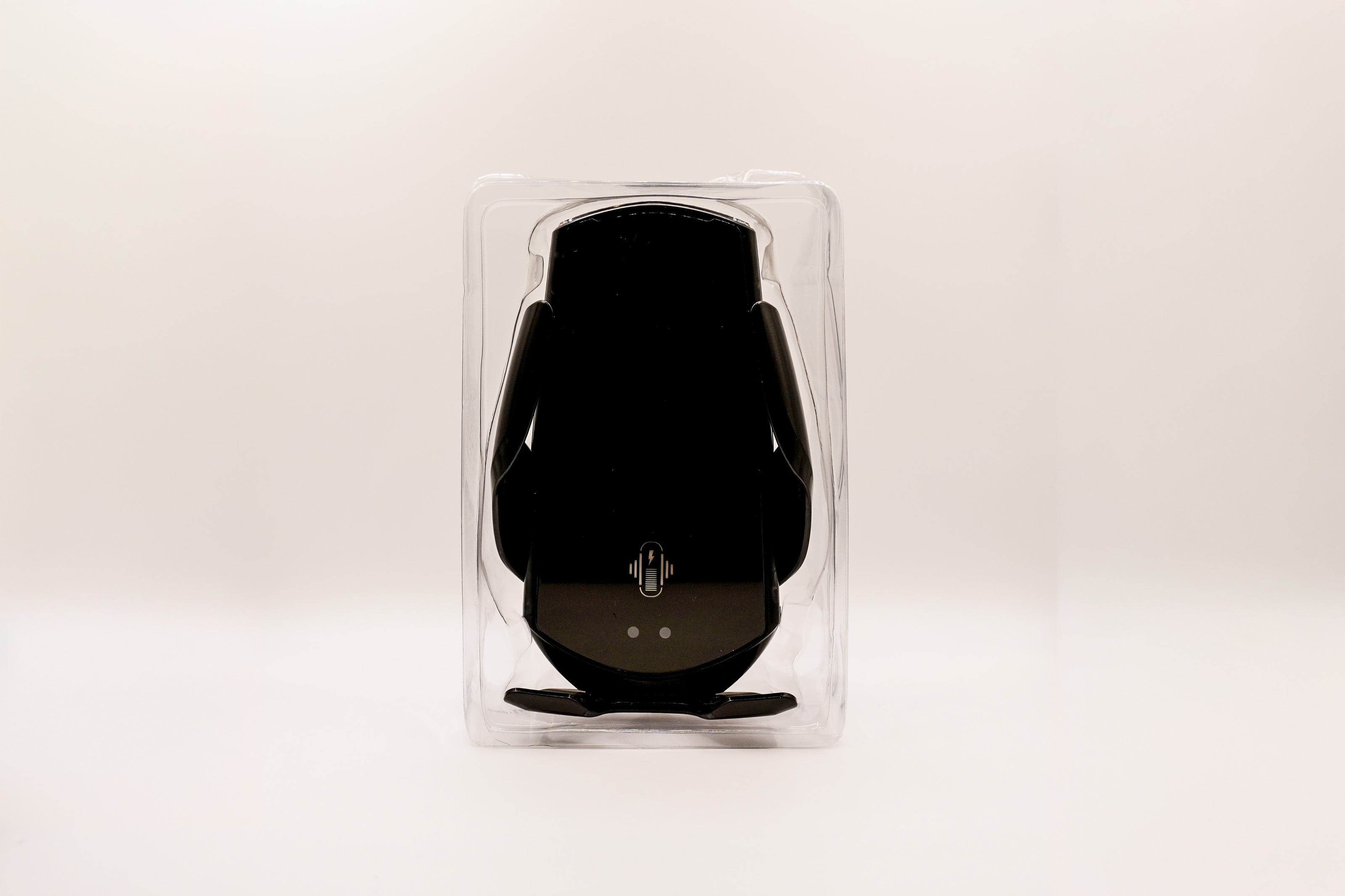 Black electronic device in clear packaging on a white background