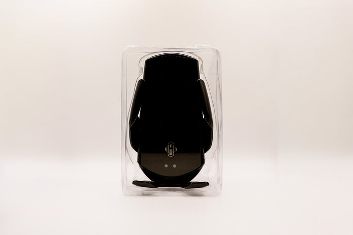 Black electronic device in clear packaging on a white background