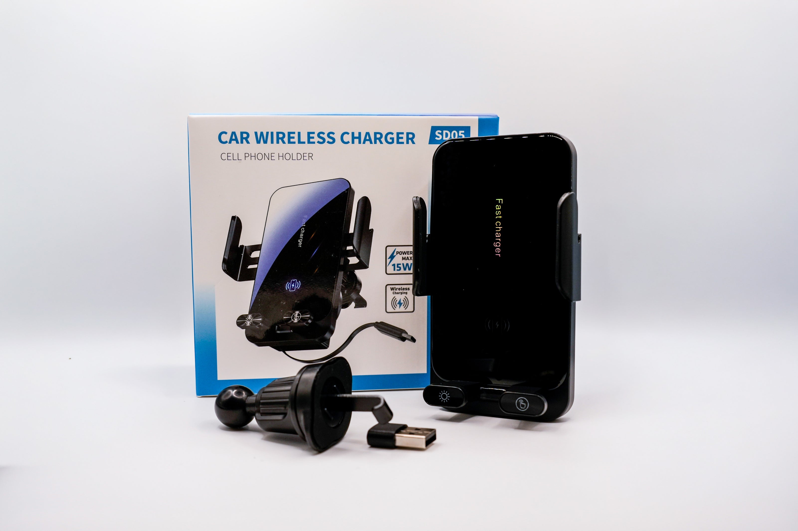 Car wireless charger with packaging and smartphone on a white background