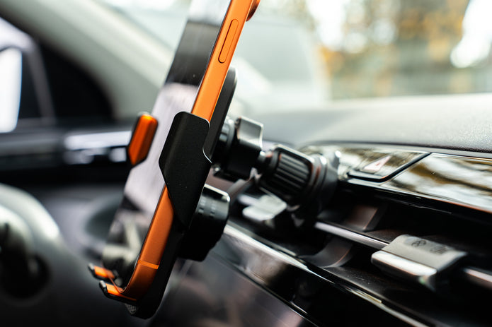 Phone holder on a car dashboard with a blurred background