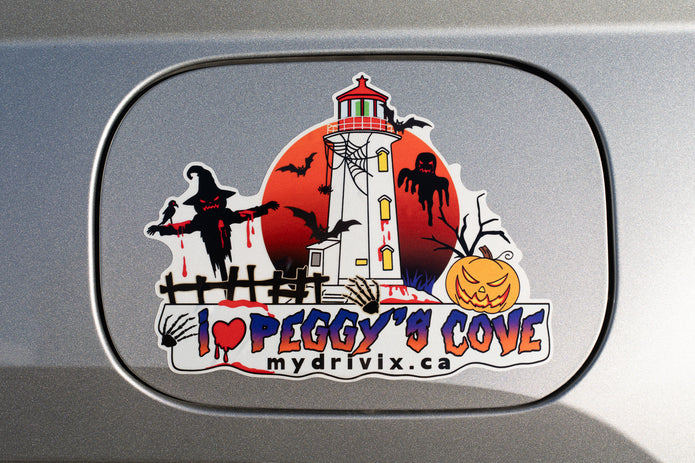 Halloween-themed sticker with a lighthouse and text on a car window