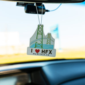 Car air freshener with 'I ❤️ HFX' text hanging from a car's rearview mirror.