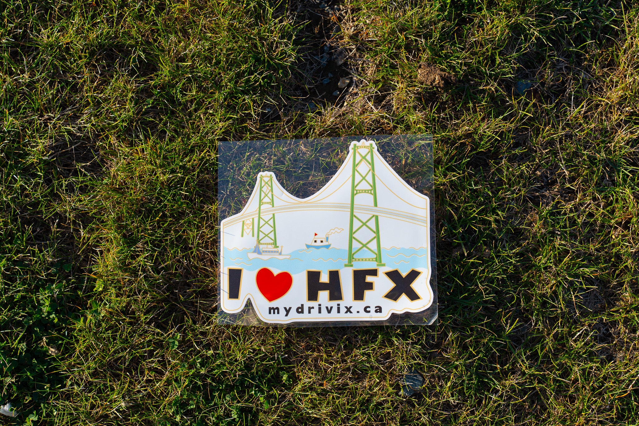 Sticker with 'I ❤️ HFX' text on a grassy background