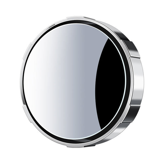 Round metallic object with reflective surface on a white background