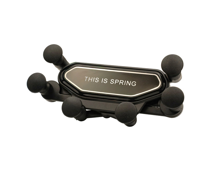 Black phone holder with 'THIS IS SPRING' text on a white background
