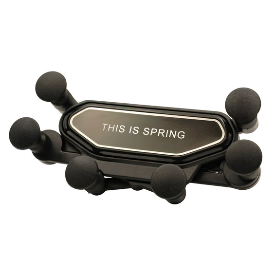 Black phone holder with 'THIS IS SPRING' text on a white background