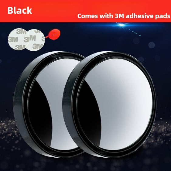 Two round black mirrors with adhesive pads on a dark background