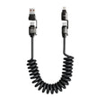 Coiled black USB cable with connectors on a white background