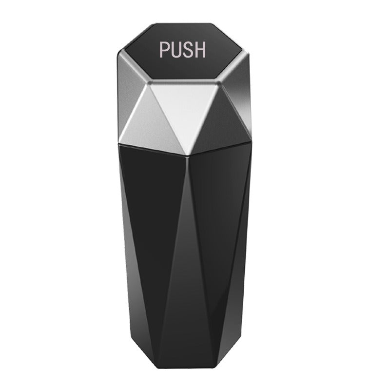 Black and silver cylindrical device with 'PUSH' label on a white background