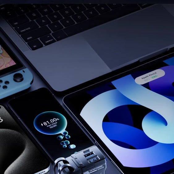 Multi-device charging station with dual output ports and data cables on a dark surface.