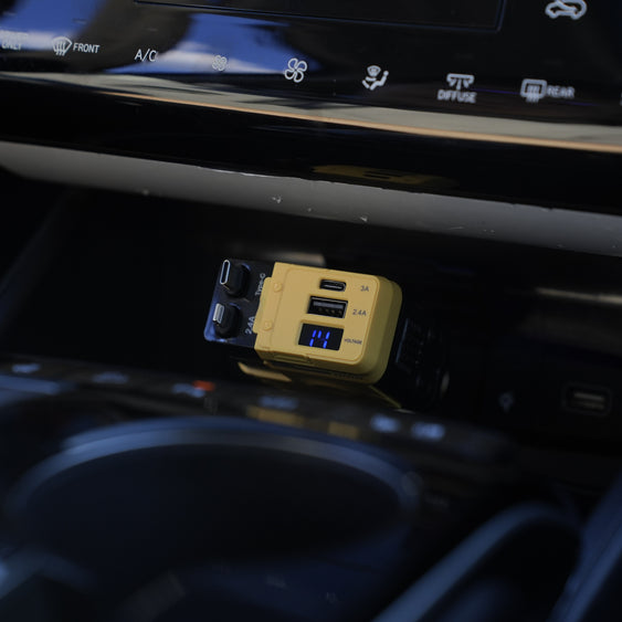 Car dashboard with a USB charger and cup holder