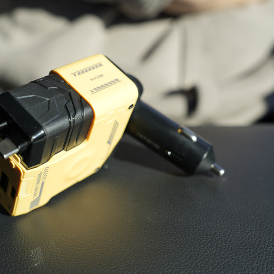 Black and gold electrical plug on a dark surface