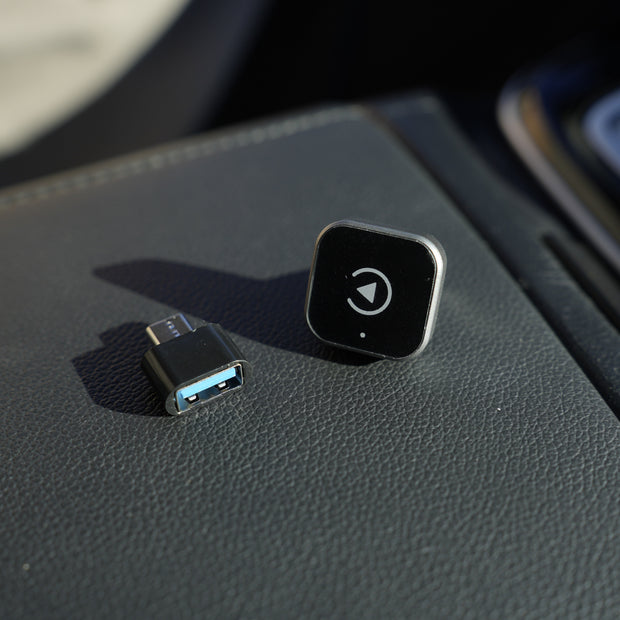 Car console with USB connector and control button on a gray surface