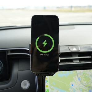 Phone mounted on a car dashboard with charging indicator