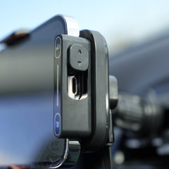 Phone mount on a car window with a blurred background