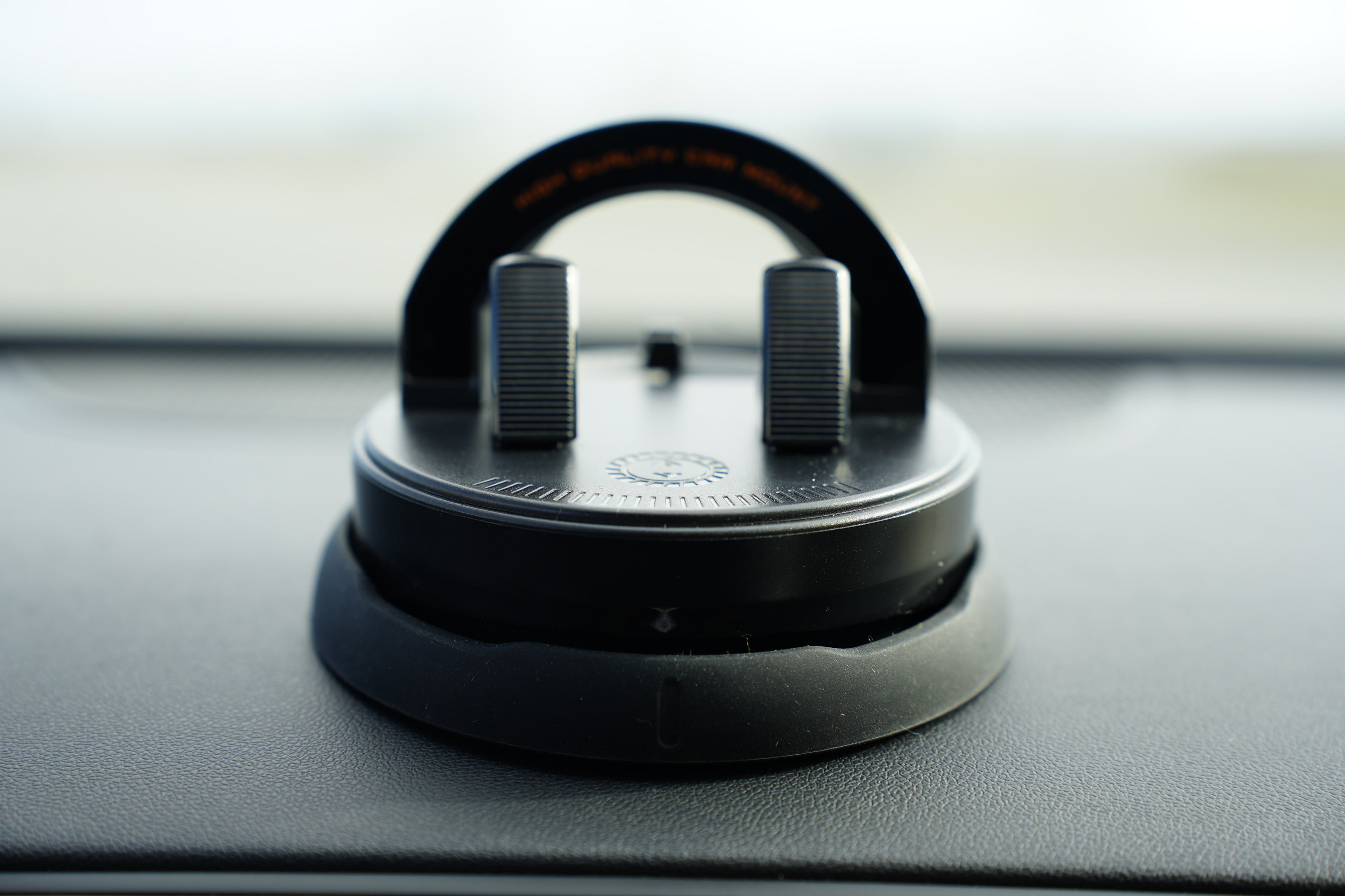 Car air freshener hanging from a clip on a car dashboard