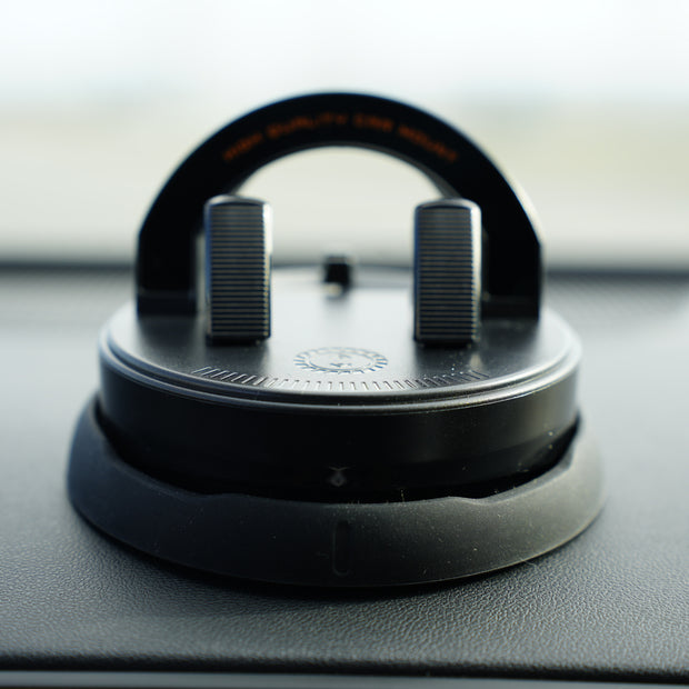 Car air freshener hanging from a clip on a car dashboard