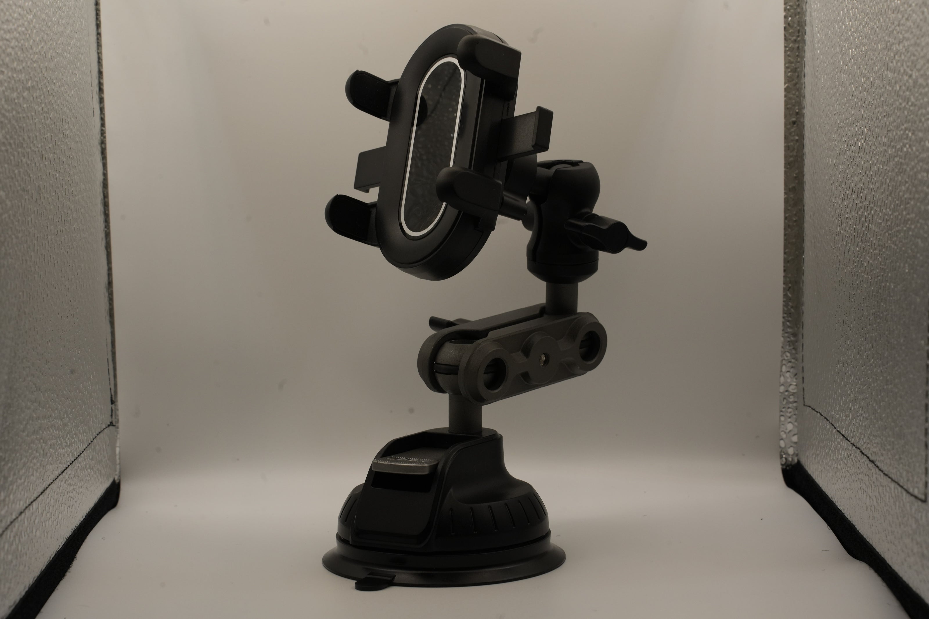 Black phone holder with suction cup on a white background