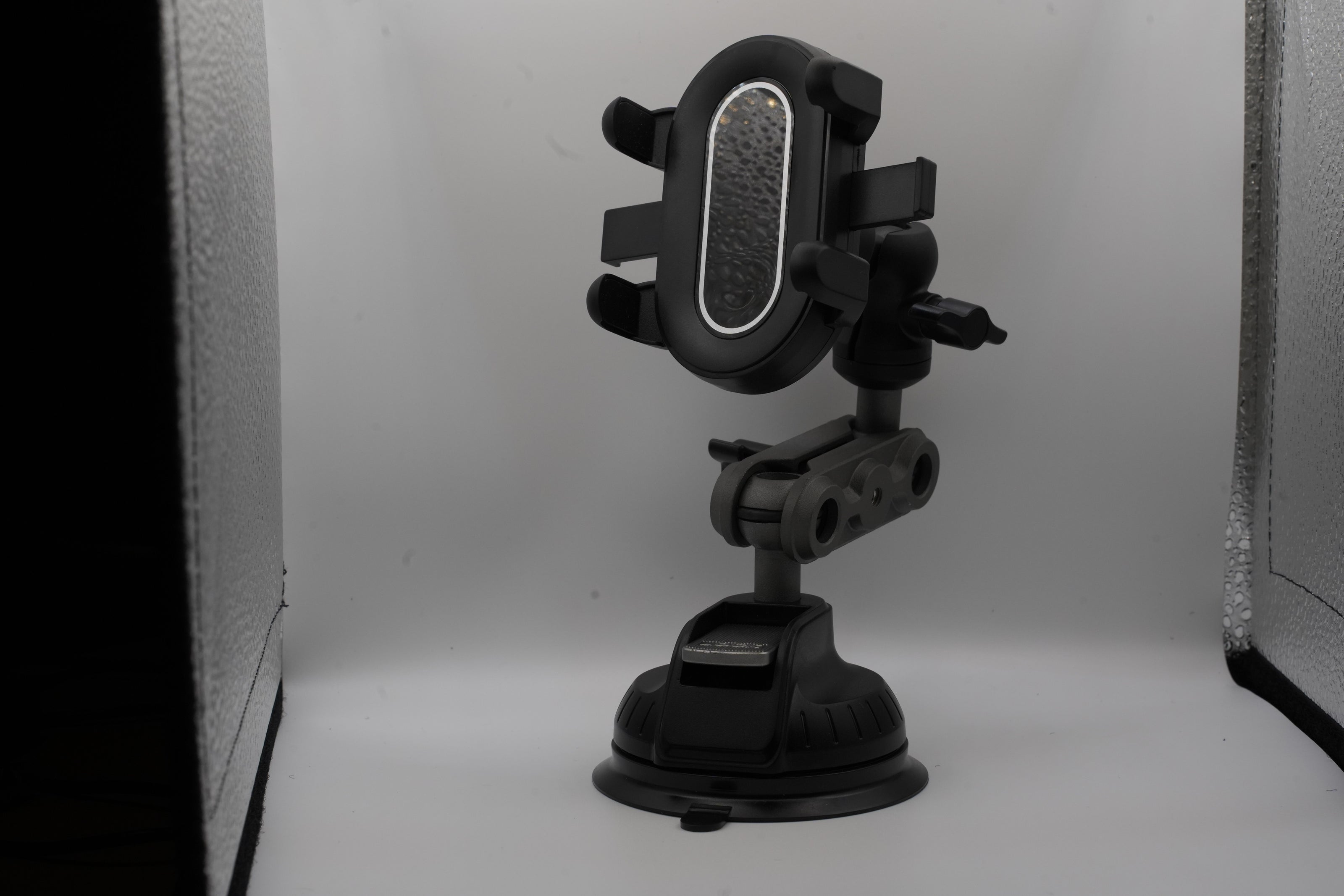 Black phone holder with suction cup on a white background