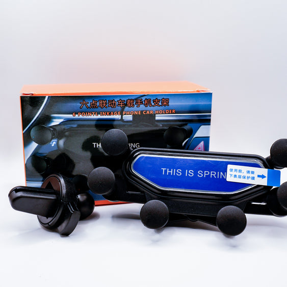 Phone car holder with 'This is Spring' branding in front of a box on a white background