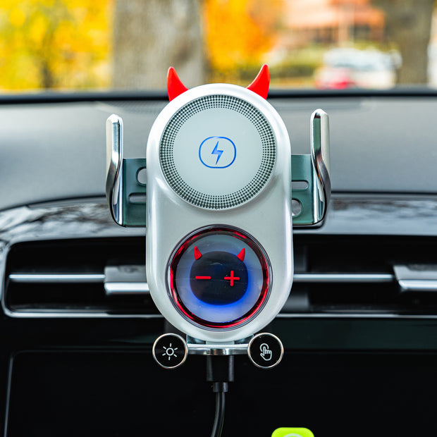 Car phone holder with devil horns and tail design on a car dashboard