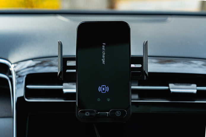 Phone mounted on a car dashboard with a charging app displayed