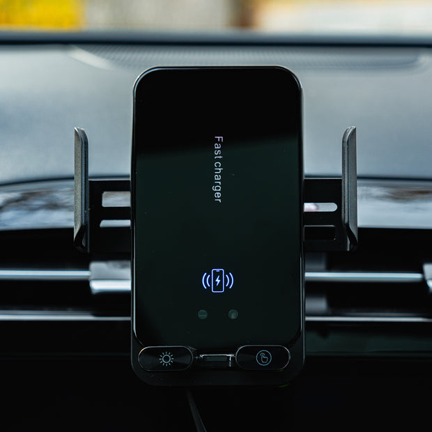 Phone mounted on a car dashboard with a charging app displayed