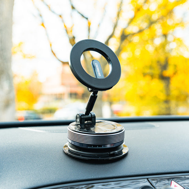 Car dashboard with a phone holder and ring light, blurred outdoor background