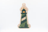 Decorative lighthouse ornament with green and beige stripes on a white background