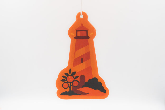 Orange lighthouse-shaped air freshener on a white background