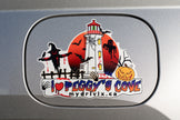 Halloween-themed sticker with a lighthouse and text on a car window
