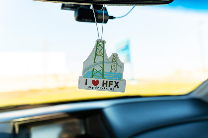 Car air freshener with 'I ❤️ HFX' text hanging from a car's rearview mirror.