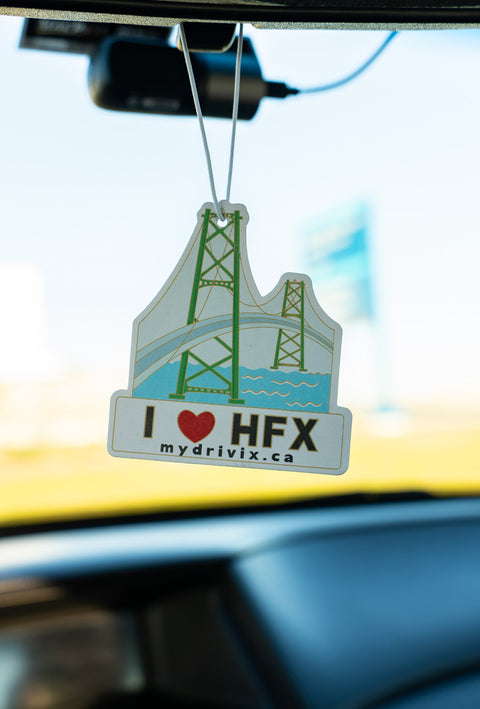 Car air freshener with 'I ❤️ HFX' text hanging from a car's rearview mirror.